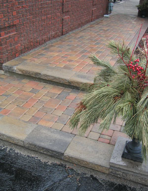 We selected a riverbed colour blend and a European-style cobble pattern which de-emphasized the large dominating wall on the left. 