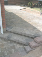 The approach from the road steps up twice only and takes drainwater away from the site