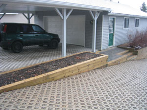 Order is created by following the lines of the building roof. Underground drainage ensures that water does not pool in the carport.